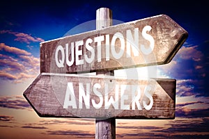 Questions, answers - wooden signpost, roadsign with two arrows