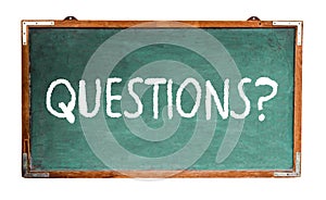 Questions? text word message in white chalk written on a wide green old grungy vintage wooden chalkboard or retro blackboard