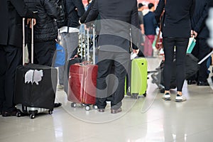 Queue of Asian people waiting at boarding gate at airport. Closeup.