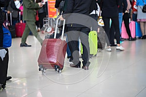 Queue of Asian people waiting at boarding gate at airport. Closeup.