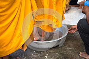 Queue of barefoot monks with foot wash ceremonial in south of Vietnam