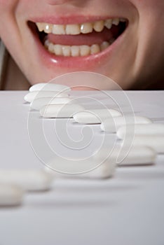 Queue of chewing gums heading to open mouth