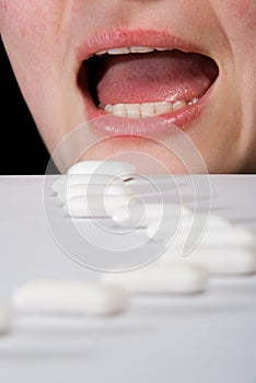 Queue of chewing gums heading to open mouth