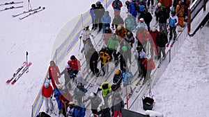 The Queue on the Ski Lift. Crowd of Skiers Stands and Crowds at Turnstile Gates