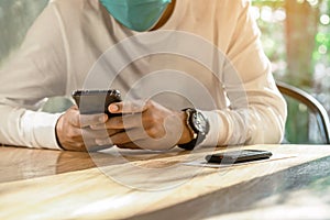 Queue Wireless Calling System Restaurant or Pager Customers System with invoice on table with blur image of man wear protective