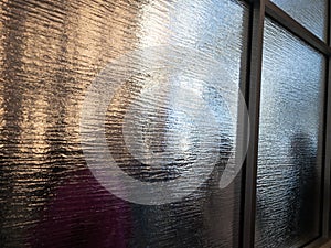 Queuing people viewed through frosted glass