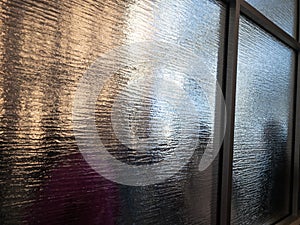 Queuing people viewed through frosted glass photo