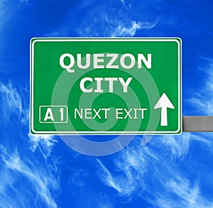 QUEZON CITY road sign against clear blue sky