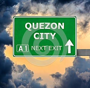 QUEZON CITY road sign against clear blue sky