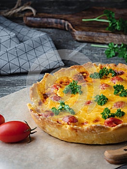 Quiche lauren - cheese vegetable pie with chicken on a wooden table in rustic style