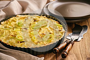 Quiche with leek and cheese on brown background. photo