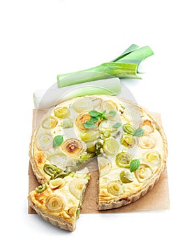 Quiche with leek and cheese isolated on white