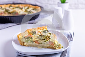 Quiche open pie with trout, broccoli and cheese. Homemade unsweetened pastries, traditional pie.