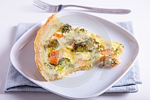 Quiche open pie with trout, broccoli and cheese. Homemade unsweetened pastries, traditional pie.