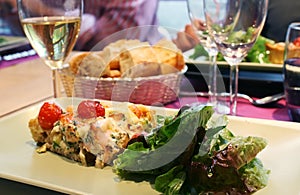 Quiche with salad and wine