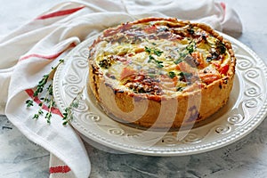 Quiche with salmon, broccoli,red pepper and thyme. photo
