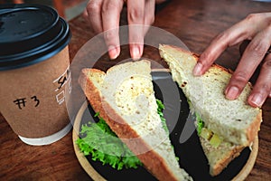 Quick bite of sandwich with coffee to start the day