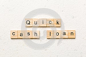 quick cash loan word written on wood block. quick cash loan text on table, concept