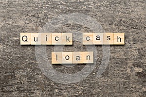 quick cash loan word written on wood block. quick cash loan text on table, concept