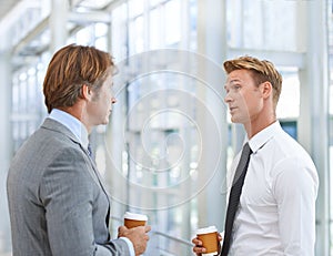 A quick catch-up over some coffee. A cropped image of two businessmen having coffee and a conversation.