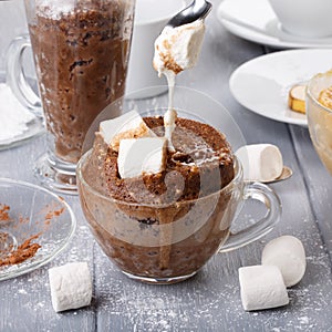 Quick chocolate cake with marshmallow in a glass mug from microwave