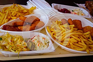 Quick lunch. French fries, fried nuggets and salads. Delicious fast food