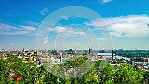 Quick motion of clouds over historical district of Kyiv - Podil at summer sunny day. Ukraine. 4K Time Lapse