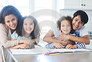 Quick squeezes between classes. a beautiful family doing homework together at the kitchen table.