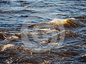 Quick water flow in a river, Nature background. Selective focus