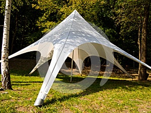 Quickly erected fabric tent in a forest glade