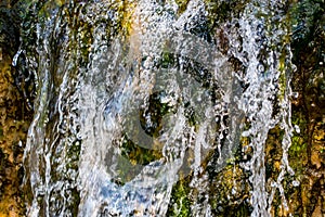 Quickly flowing mountain stream, close-up flowing water from the