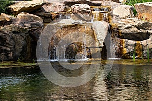 Quickly flowing mountain stream, close-up flowing water from the rock