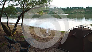 Quickly folding tent. Camp by the river in the forest. Camping and hiking. Light and portable chairs and a table. Vacation and equ