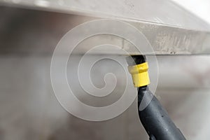 quickly remove tough frozen grease and grime from the surface of a built-in hob, gas hob, cooktop with a steam cleaner photo