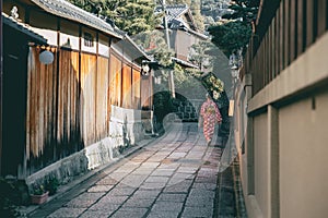 quiet alley in Kyoto Gion district with Japanese Kimono woman walking, Japan ancient way of life