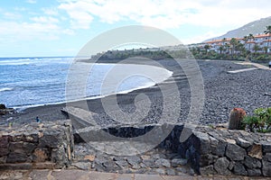 The quiet beach of La Caleta with volcanic black sand in the Atlantic ocean, perfect for relaxing. Caleta de Interian, Tenerife, S photo