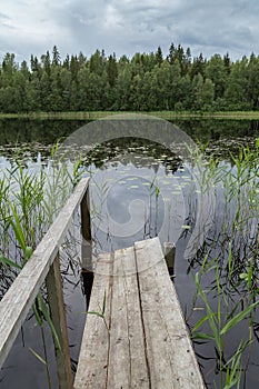 Quiet and calm lake and a wooden pier in Finland