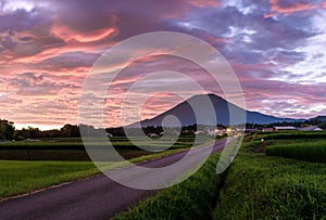 Quiet country road leads to Mt. Daisen and dramatic sunrise clouds