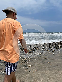 Quiet man walking on the sand in the sea photo
