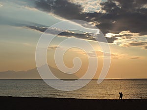 Quiet Morning, Lonely Fisherman on The Beach