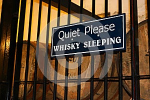 Quiet Please Whiskey Sleeping Sign with Barrels of Whiskey