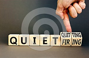 Quiet quitting or firing symbol. Concept words Quiet quitting Quiet firing on cubes. Businessman hand. Beautiful grey table grey