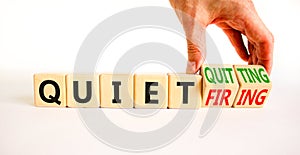 Quiet quitting or firing symbol. Concept words Quiet quitting Quiet firing on cubes. Businessman hand. Beautiful white table white