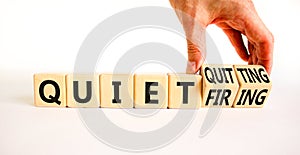Quiet quitting or firing symbol. Concept words Quiet quitting Quiet firing on cubes. Businessman hand. Beautiful white table white