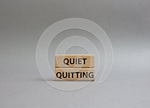 Quiet quitting symbol. Concept word Quiet quitting on wooden blocks. Beautiful grey background. Business and Quiet quitting