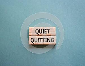 Quiet quitting symbol. Concept word Quiet quitting on wooden blocks. Beautiful grey green background. Business and Quiet quitting
