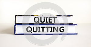 Quiet quitting symbol. Concept words Quiet quitting on books. Beautiful white table white background. Business and quiet quitting
