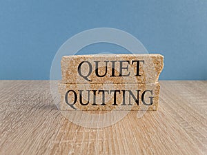 Quiet quitting symbol. Concept words Quiet quitting on brick blocks.