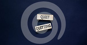 Quiet quitting symbol. Concept words Quiet quitting on wooden blocks. Beautiful black table black background. Business and quiet