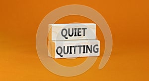 Quiet quitting symbol. Concept words Quiet quitting on wooden blocks. Beautiful orange table orange background. Business and quiet